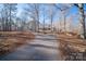 Long driveway leads to a house nestled in the woods at 209 Meadowridge Dr, Maiden, NC 28650