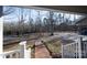 View from porch showcasing circular driveway and woods at 209 Meadowridge Dr, Maiden, NC 28650