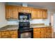 Kitchen boasts granite countertops and black appliances at 209 Meadowridge Dr, Maiden, NC 28650