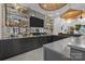 Modern bar with dark cabinetry, quartz countertops, and mirrored backsplash at 2130 Ferncliff Rd, Charlotte, NC 28211