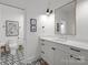 Bathroom with white vanity, geometric floor tiles, and a large mirror at 2130 Ferncliff Rd, Charlotte, NC 28211