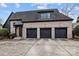 Three-car garage, brick facade, and a charming covered entryway at 2130 Ferncliff Rd, Charlotte, NC 28211