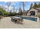 Inviting pool area with patio furniture and dining table at 2130 Ferncliff Rd, Charlotte, NC 28211