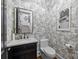 Stylish powder room with marble vanity and toile wallpaper at 2130 Ferncliff Rd, Charlotte, NC 28211