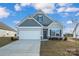 Gray siding ranch home with a two-car garage and landscaped lawn at 2234 Catawba Trace Dr, Catawba, NC 28609