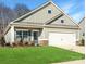 Single-story house with gray siding, brick accents, and a two-car garage at 2242 Catawba Trace Dr, Catawba, NC 28609