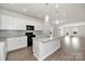 Open concept kitchen with island, white cabinets, and hardwood floors at 2242 Catawba Trace Dr, Catawba, NC 28609