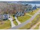 Aerial view of lakefront homes and a curved road at 225 South Shore Dr, Belmont, NC 28012