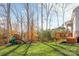 Spacious backyard with deck, playset, and wooded area at 225 South Shore Dr, Belmont, NC 28012