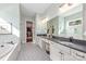 Spa-like bathroom with a soaking tub, double vanity, and patterned tile floor at 225 South Shore Dr, Belmont, NC 28012