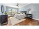 Spacious bedroom with light blue walls, hardwood floors, and a ceiling fan at 225 South Shore Dr, Belmont, NC 28012