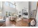 Two-story living room with hardwood floors, built-in shelving, and fireplace at 225 South Shore Dr, Belmont, NC 28012