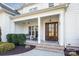 Inviting front porch with wooden door and seating at 225 South Shore Dr, Belmont, NC 28012