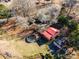 Aerial view of a charming house with a red roof, above ground pool, and a detached garage at 2407 Brookside Ave, Kannapolis, NC 28081