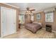 Bedroom featuring a ceiling fan, hardwood floors and two windows at 2407 Brookside Ave, Kannapolis, NC 28081