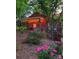 Charming outdoor space with covered patio, string lights, and beautiful flower garden at 2407 Brookside Ave, Kannapolis, NC 28081