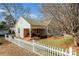 Charming home with a welcoming front porch, cozy seating, and a classic white picket fence at 2407 Brookside Ave, Kannapolis, NC 28081