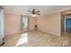 Bright living room with beautiful floors, neutral paint, large window, and modern ceiling fan at 2407 Brookside Ave, Kannapolis, NC 28081