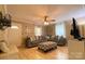 Inviting living room with a large gray sectional sofa, hardwood floors, and ample natural light at 2407 Brookside Ave, Kannapolis, NC 28081