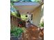 A covered porch with potted plants and foliage, creating a tranquil outdoor space at 2407 Brookside Ave, Kannapolis, NC 28081