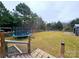 Large backyard with trampoline and wood pile at 249 Planters Row Rd, Iron Station, NC 28080