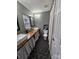 Modern bathroom with hexagon tile flooring, double vanity, and a rustic wooden countertop at 249 Planters Row Rd, Iron Station, NC 28080