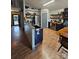 Farmhouse kitchen with stainless steel appliances and open shelving at 249 Planters Row Rd, Iron Station, NC 28080