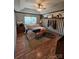 Large main bedroom with a king-size bed, ceiling fan, and a rustic wood accent wall at 249 Planters Row Rd, Iron Station, NC 28080