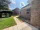 Brick home with backyard walkway, landscaping, and privacy fence at 2509 Calgary Pl, Concord, NC 28027