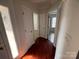 Hardwood floor hallway with doors to bedrooms and backyard at 2509 Calgary Pl, Concord, NC 28027