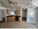 Bright kitchen with wood cabinets, tile floor, and access to backyard at 2509 Calgary Pl, Concord, NC 28027