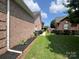 Brick home with side yard and grassy area at 2509 Calgary Pl, Concord, NC 28027