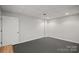 Spacious finished basement room with a door and dark grey flooring at 2635 Queens Dr, Lincolnton, NC 28092