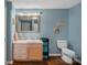 Basement bathroom with light blue walls, tiled vanity, and updated fixtures at 2635 Queens Dr, Lincolnton, NC 28092