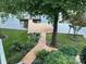 Landscaped backyard with wooden walkway leading to dock at 273 Leeward Point Loop, Taylorsville, NC 28681