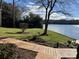 Landscaped backyard with lake access and wooden walkway at 273 Leeward Point Loop, Taylorsville, NC 28681