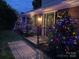 Landscaped front yard with decorated trees for holidays at 273 Leeward Point Loop, Taylorsville, NC 28681