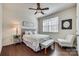 Bedroom with hardwood floors, ceiling fan, and gray bedding at 273 Sweet Briar Dr, Fort Mill, SC 29707