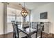 Dining room with dark wood table, gray curtains, and an orb chandelier at 273 Sweet Briar Dr, Fort Mill, SC 29707