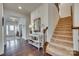 Bright entryway with staircase, dark hardwood floors, and decorative console table at 273 Sweet Briar Dr, Fort Mill, SC 29707