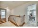 Upstairs hallway with wood railing and carpet flooring at 273 Sweet Briar Dr, Fort Mill, SC 29707