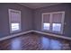 Simple bedroom with hardwood floors and multiple windows at 303 N Gaston St, Kings Mountain, NC 28086