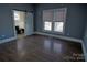 Bedroom with dark hardwood floors and barn door to bathroom at 303 N Gaston St, Kings Mountain, NC 28086