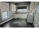 Kitchen with white cabinets, mosaic backsplash and flooring at 303 N Gaston St, Kings Mountain, NC 28086