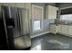 Stainless steel refrigerator in kitchen with white cabinets at 303 N Gaston St, Kings Mountain, NC 28086