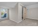 Bedroom with carpet, window, and barn door to closet at 336 3Rd Se St, Hickory, NC 28602