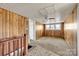 Bedroom featuring wood paneled walls, ceiling fan, and natural light from multiple windows at 34 Lee Rd, Stony Point, NC 28678