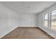 Bright bedroom with painted wood paneled walls, neutral carpet, and natural light from double windows at 34 Lee Rd, Stony Point, NC 28678