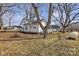 Charming home with white siding, a metal carport, and a spacious yard with mature trees at 34 Lee Rd, Stony Point, NC 28678