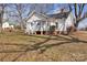 Home exterior with a small front porch, classic white paint, and mature trees at 34 Lee Rd, Stony Point, NC 28678